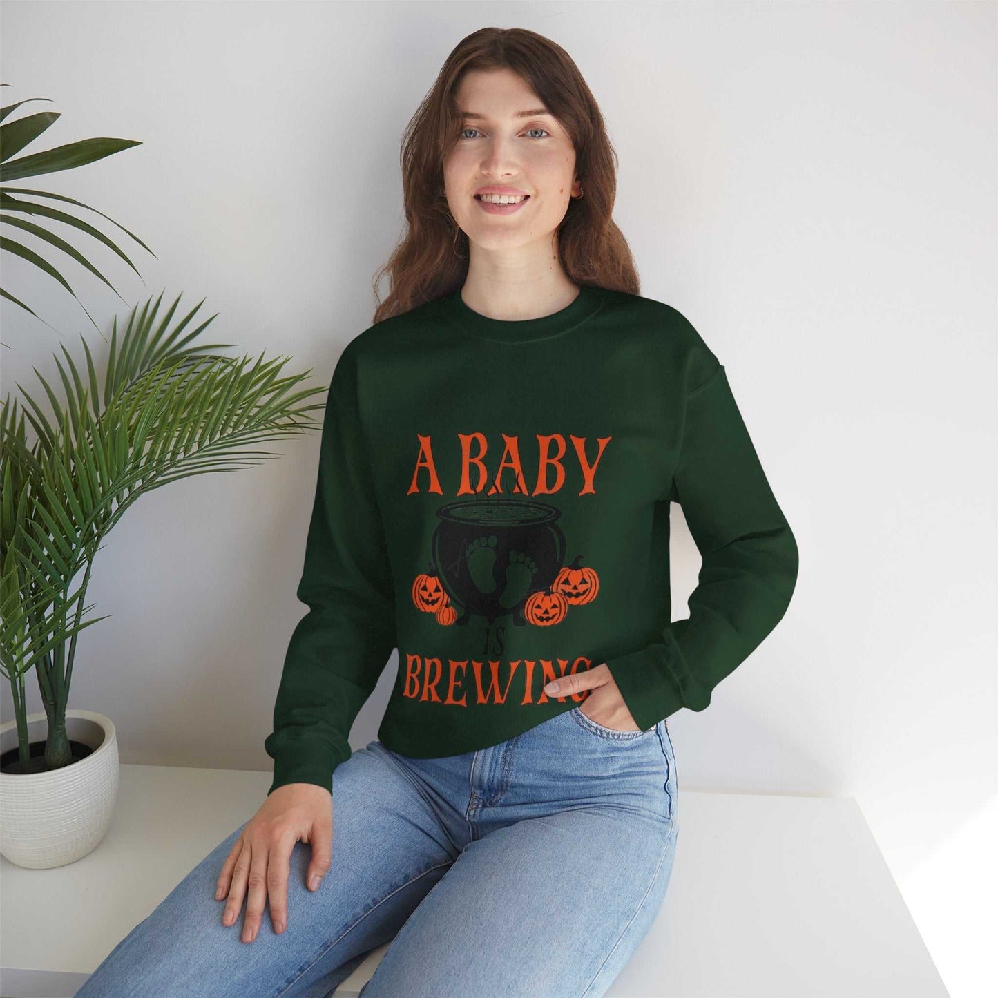 Brewing Sweetshirt featuring "A Baby Is Brewing" design, ideal for Halloween maternity announcements, made from polyester and cotton blend.