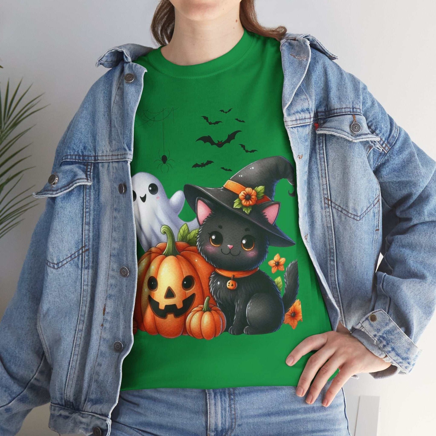 Cute Halloween cat design on kids shirt with ghost and pumpkin graphics, perfect for autumn spooky season.