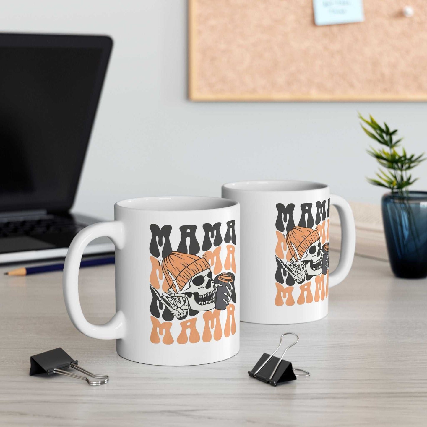 Mama Coffee Halloween Mugs with skeleton design on desk.