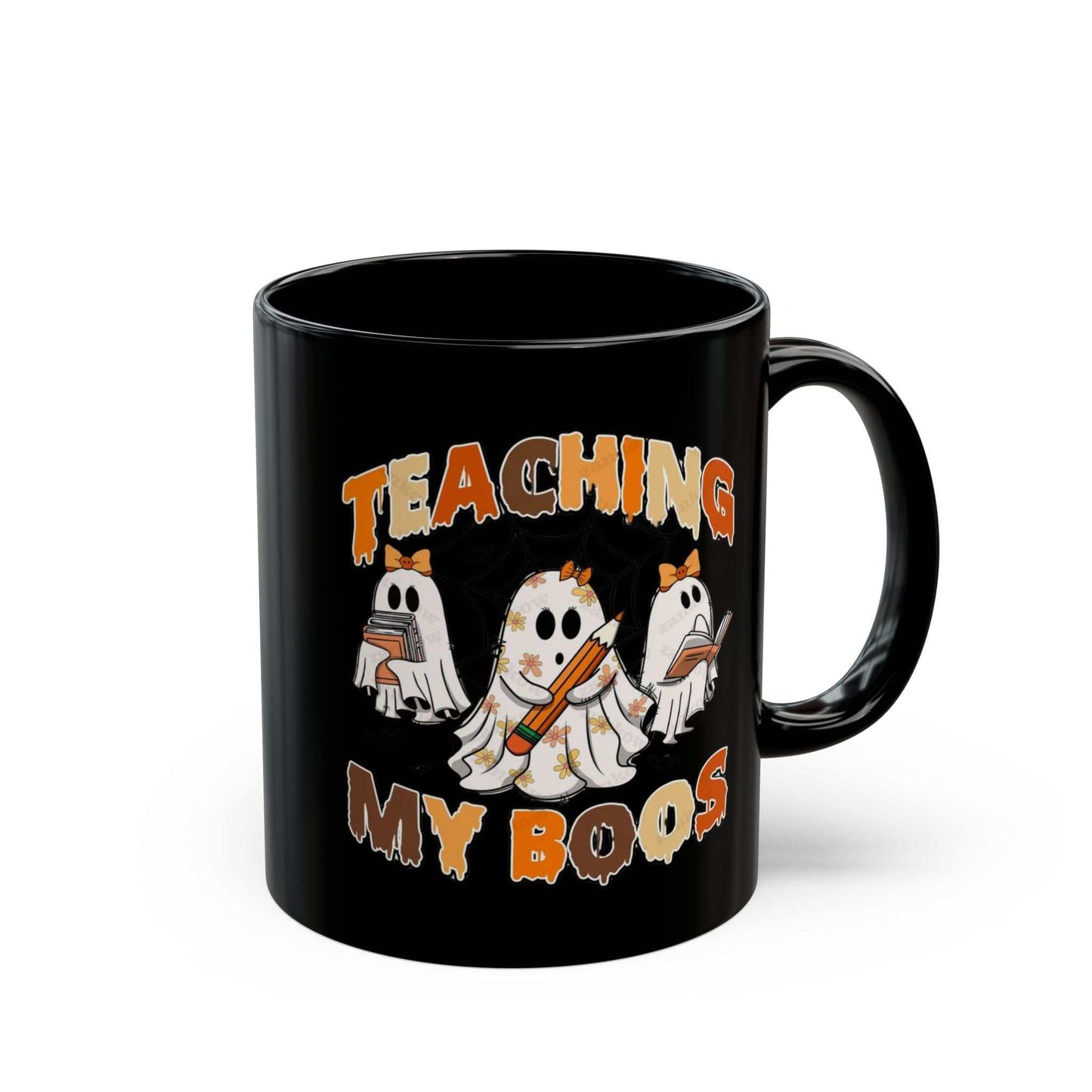 Black ceramic mug with "Teaching My Boos" design featuring playful ghost illustrations for Halloween.