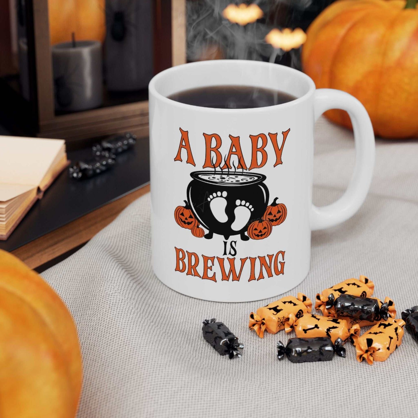 Ceramic mug with "A Baby is Brewing" design, perfect for Halloween pregnancy announcements, BPA-free, microwave and dishwasher-safe.
