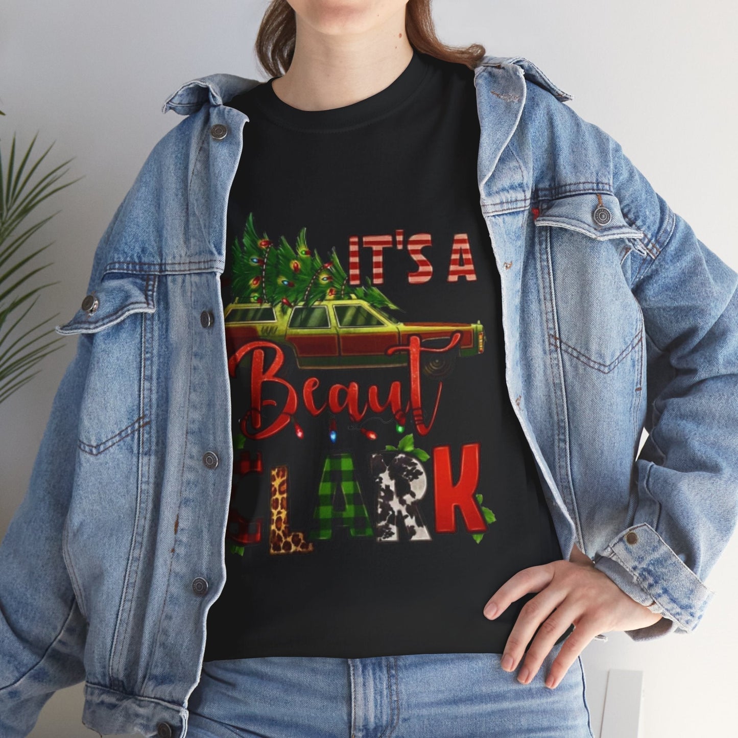 Retro "It's A Beaut Clark" Christmas shirt featuring vintage holiday design on black tee with denim jacket.