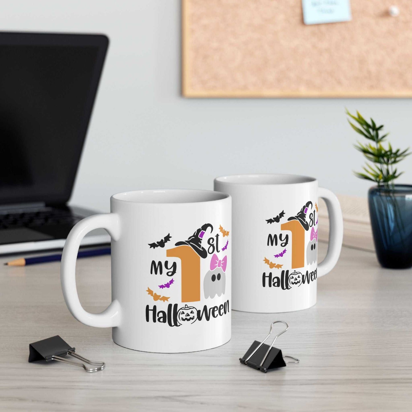 Baby Ghost My 1st Halloween ceramic mugs with colorful design on table.