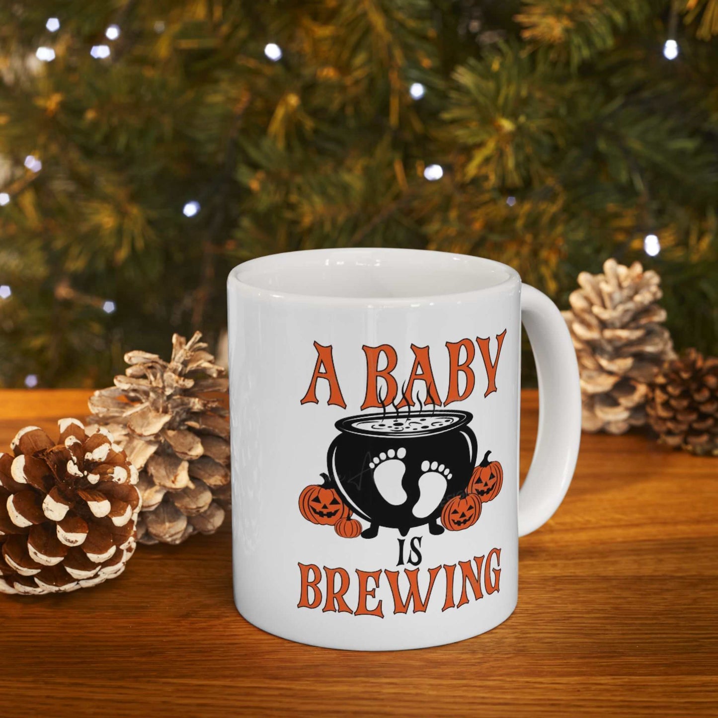 Ceramic coffee mug with "A Baby is Brewing" design, perfect for Halloween pregnancy announcements.