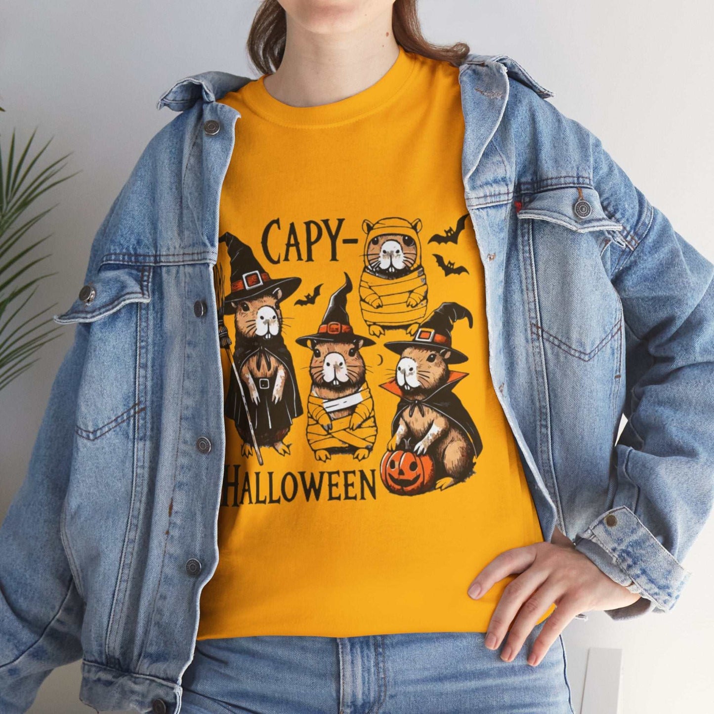 Unisex Halloween Capybara Shirt with spooky design and pumpkins.