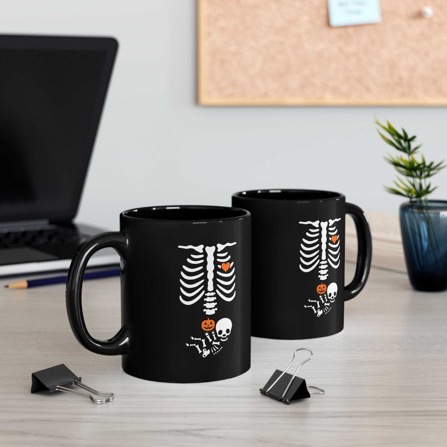 Black Halloween maternity mugs with skeleton design, perfect for pregnancy announcements and gifts.