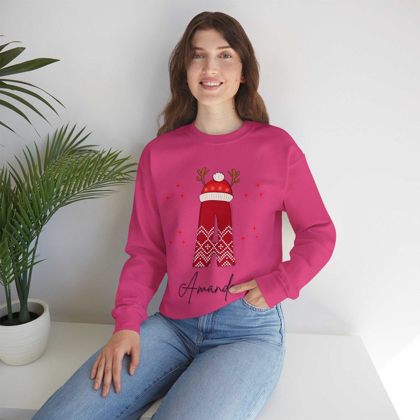 Woman wearing a personalized red Christmas sweatshirt with festive reindeer design.