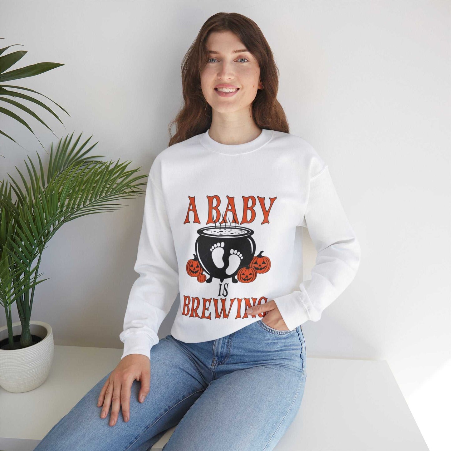 Unisex 'A Baby Is Brewing' sweatshirt for Halloween maternity announcement, featuring a cozy blend of polyester and cotton.