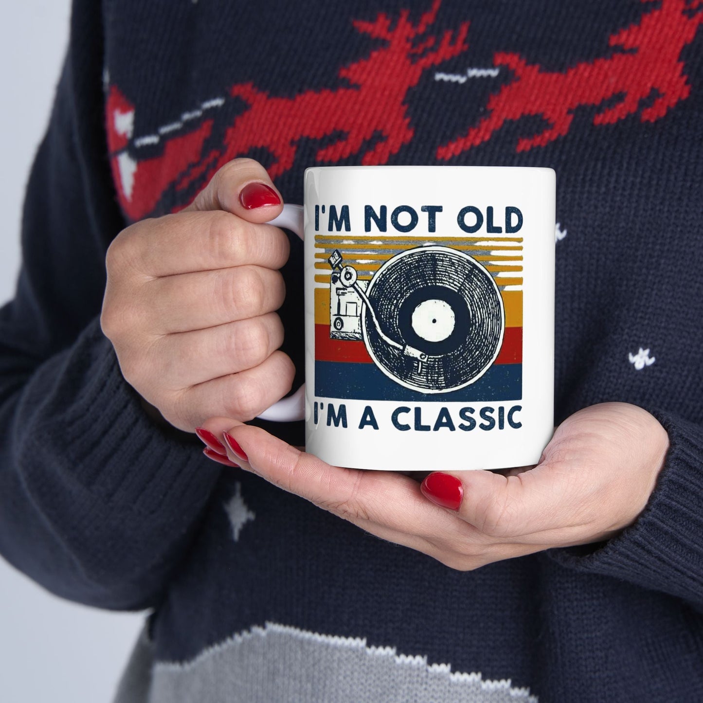 Vintage-inspired ceramic mug with "I'm Not Old, I'm A Classic" design, held by person with red nails, displaying vibrant colors and playful illustration.