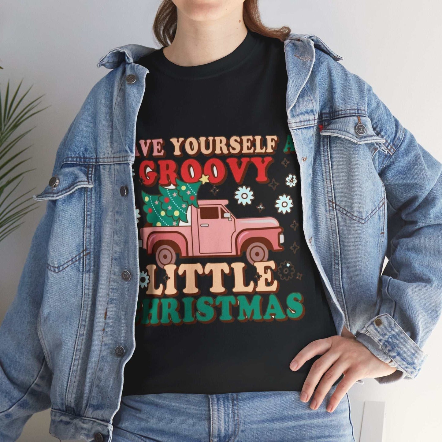 Retro Christmas shirt with groovy festive design and pink truck graphic, perfect holiday gift.