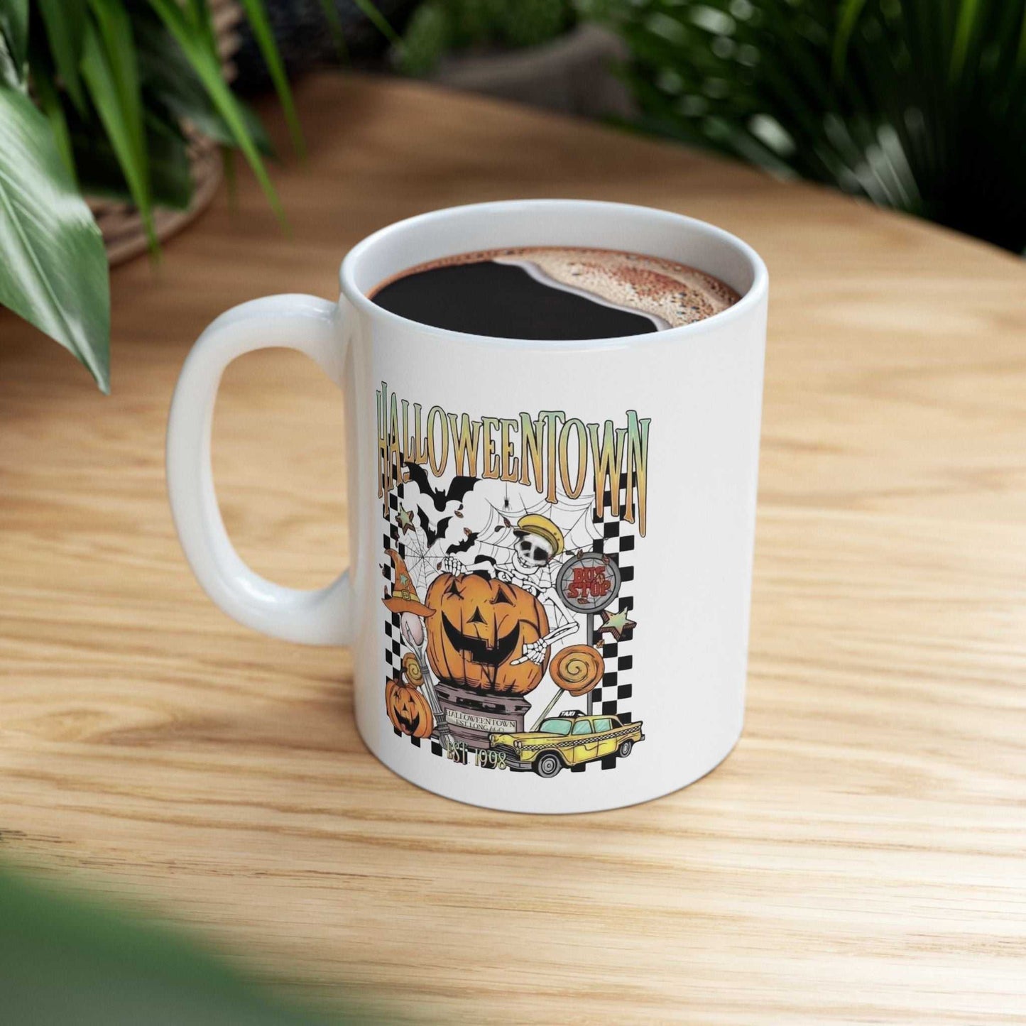 Retro Halloweentown mug featuring spooky pumpkin and ghost design on a wooden table.