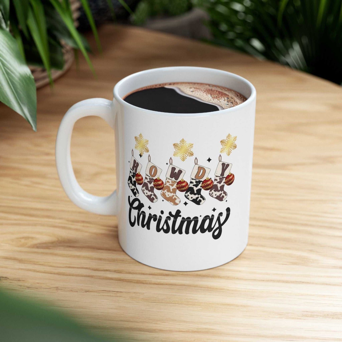 Howdy Christmas mug with western festive design on wooden table.