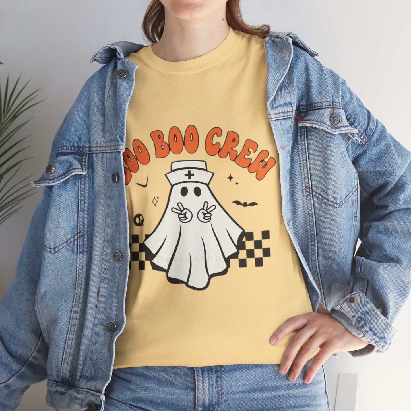 Yellow "Boo Nurse Crew Halloween" t-shirt with ghost graphic, worn under a denim jacket.
