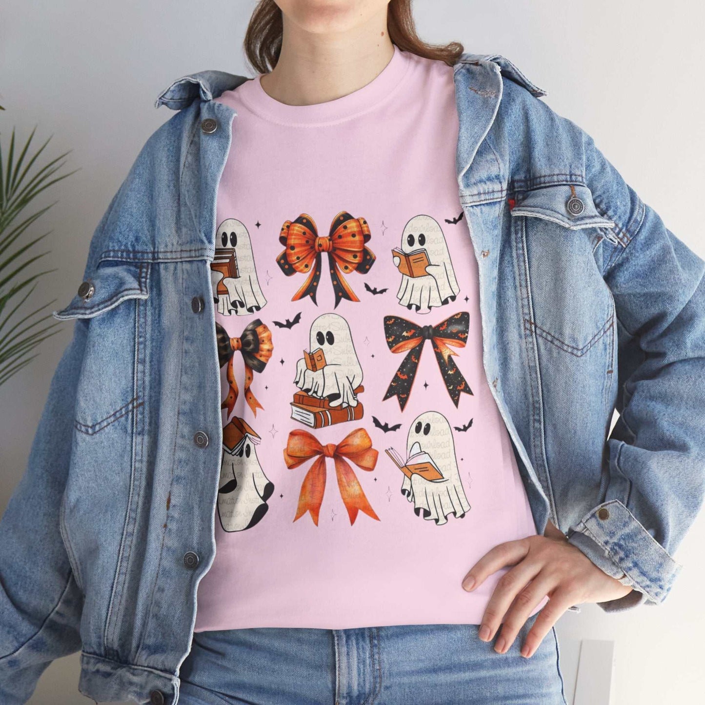 Unisex heavy cotton tee with playful ghost and book print, featuring Halloween-themed bows and vibrant design.