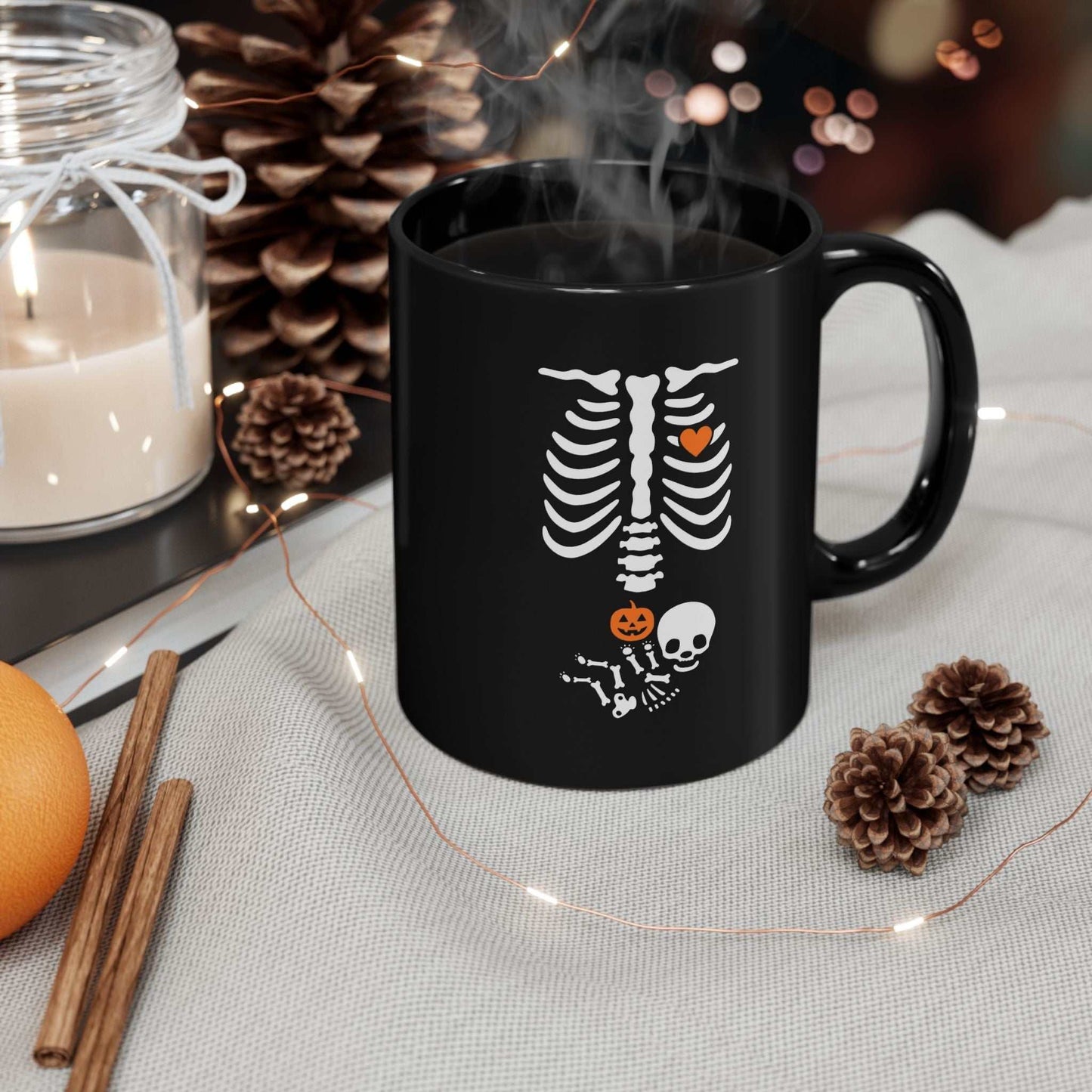 Black ceramic Halloween maternity mug with a skeleton design, perfect for pregnancy announcements and new moms.