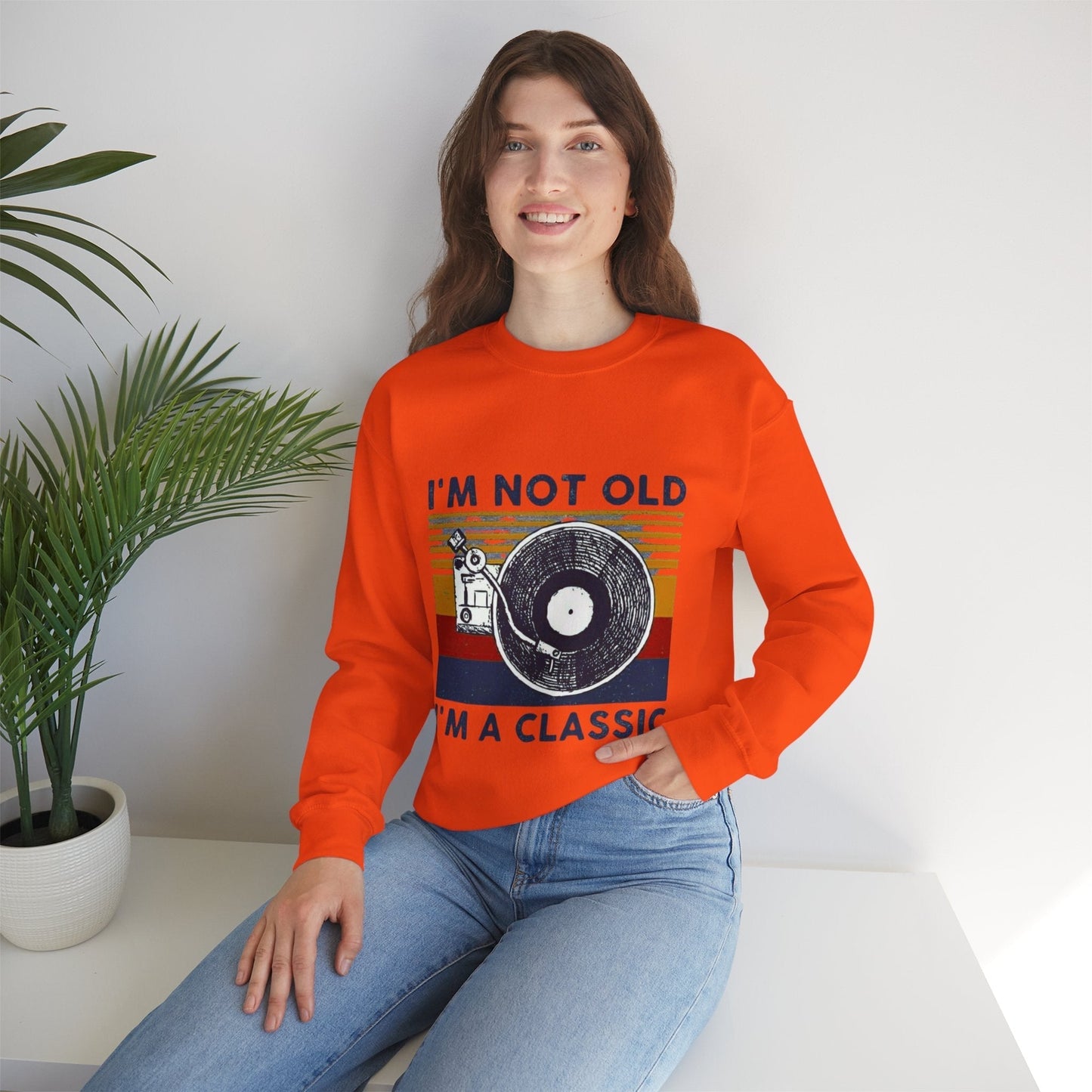 Unisex orange sweatshirt with "I'm Not Old I'm a Classic" vintage design, featuring a vinyl record graphic.