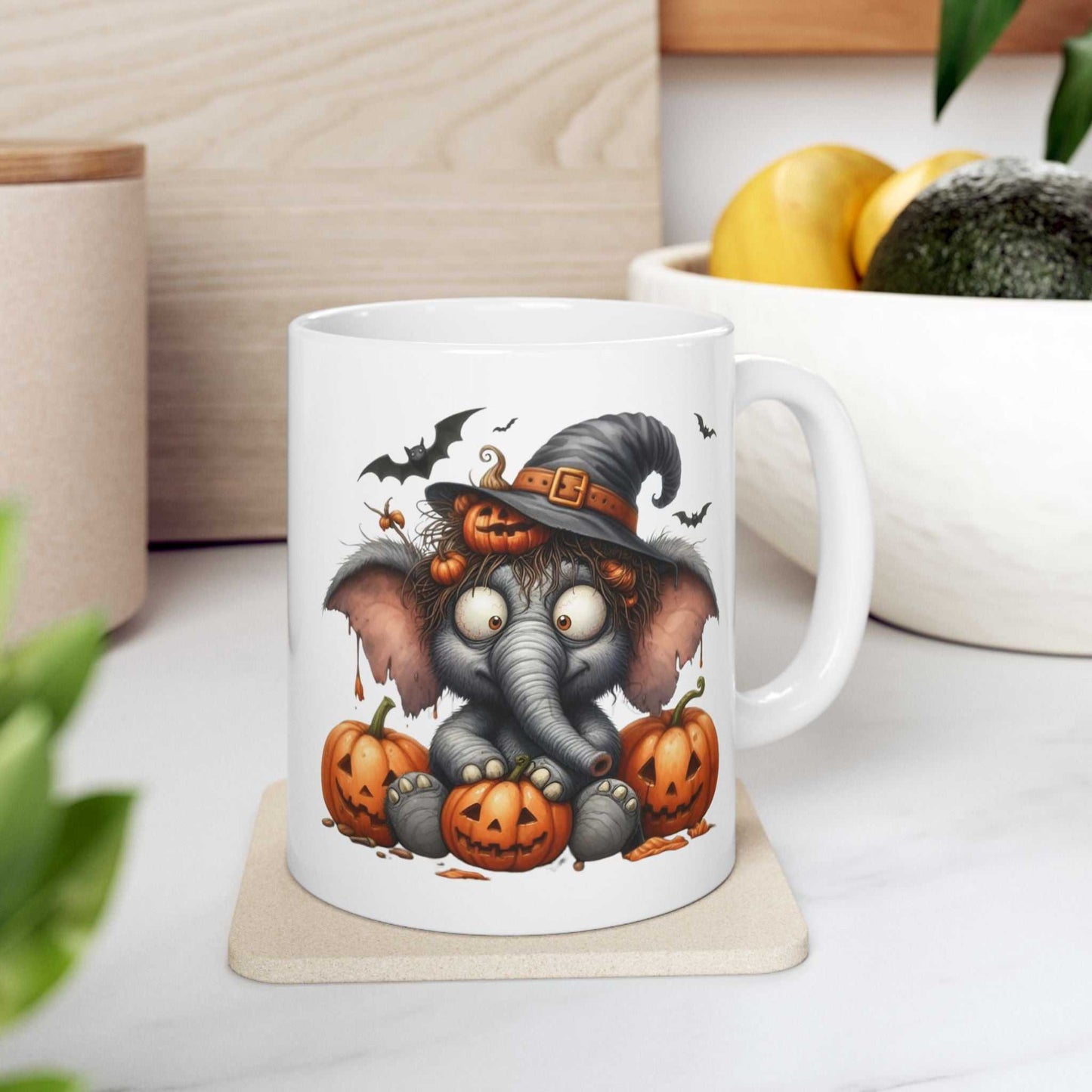 Funny Elephant Halloween mug with cartoon design featuring an elephant in a witch hat surrounded by pumpkins, perfect for spooky season.