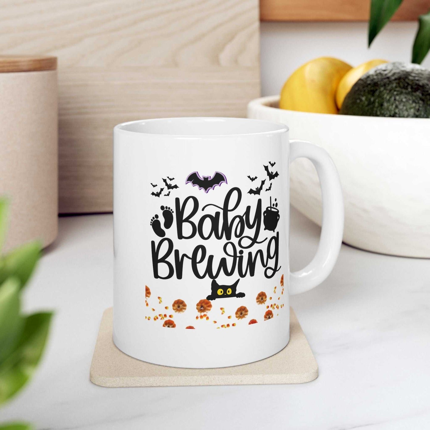 Baby Brewing Halloween Mugs featuring spooky design on white ceramic coffee cup, perfect for pregnancy announcements.
