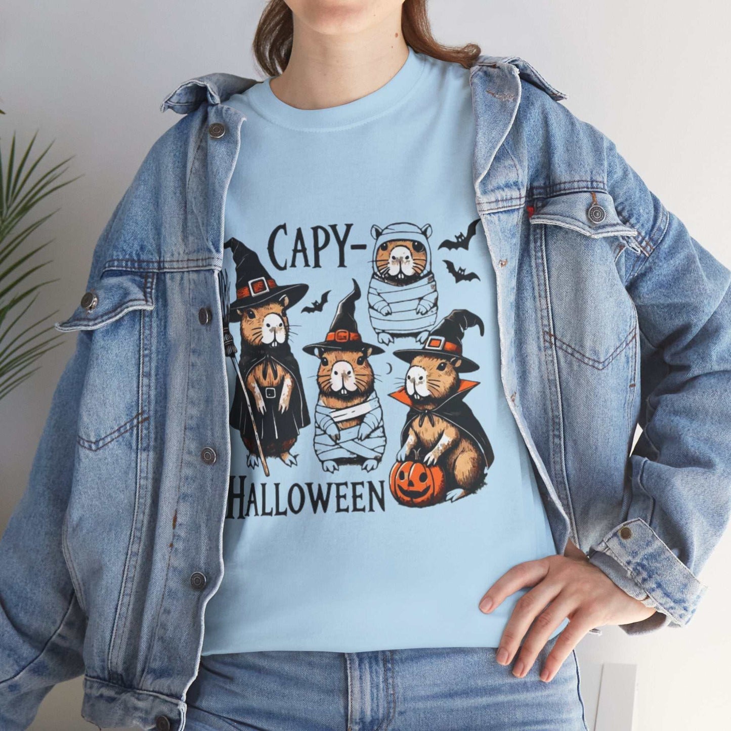 Halloween Capybara Shirt featuring funny capybaras in spooky costumes with pumpkins, perfect for Halloween.