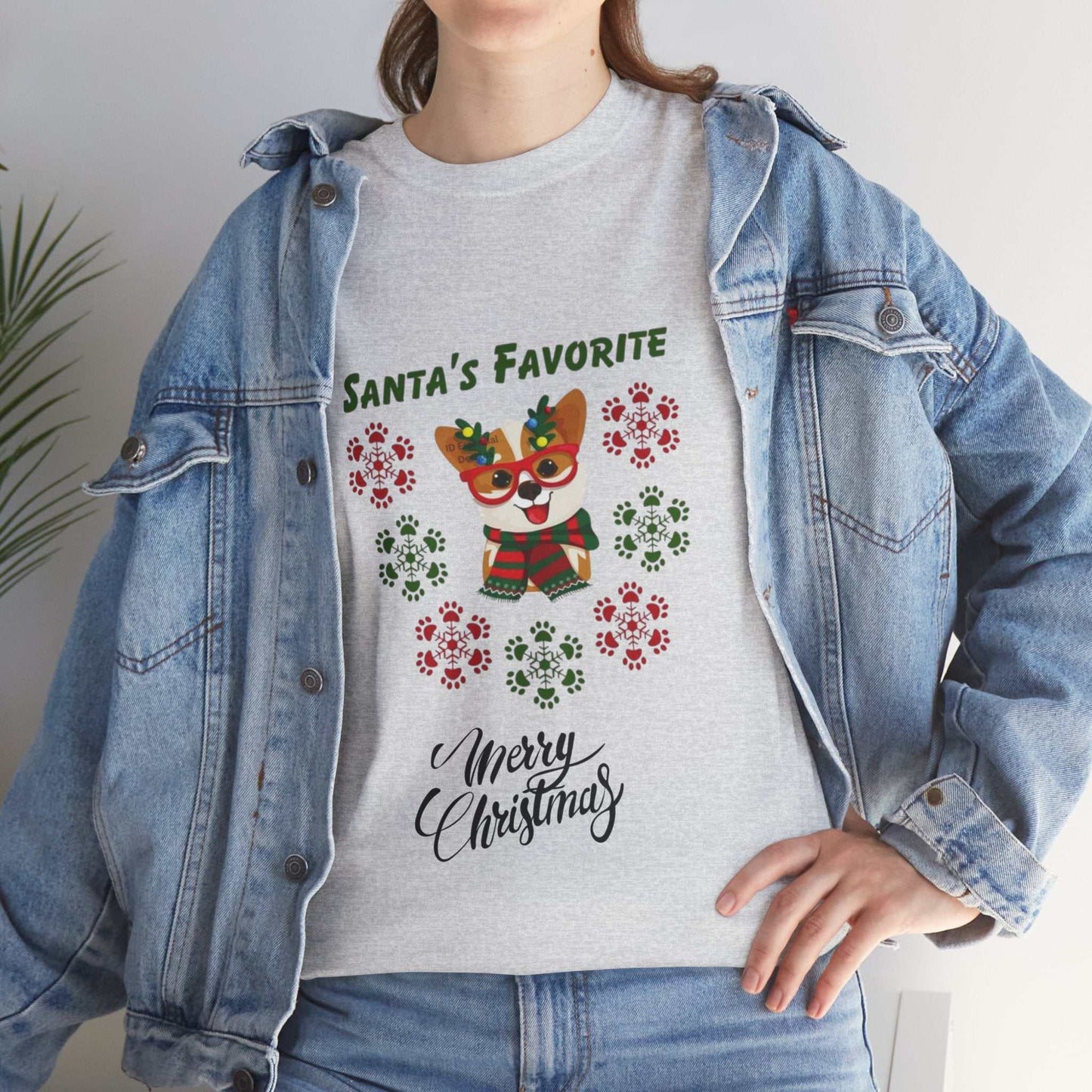 Person wearing "Santa's Favorite Dog" Christmas shirt with festive colors and playful design.