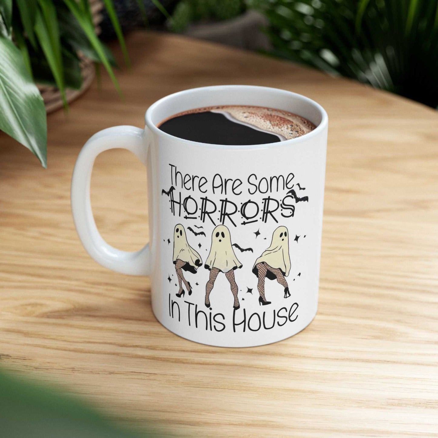 Funny Halloween mug with "There Are Some Horrors in This House" design, ceramic, personalized, ideal gift.