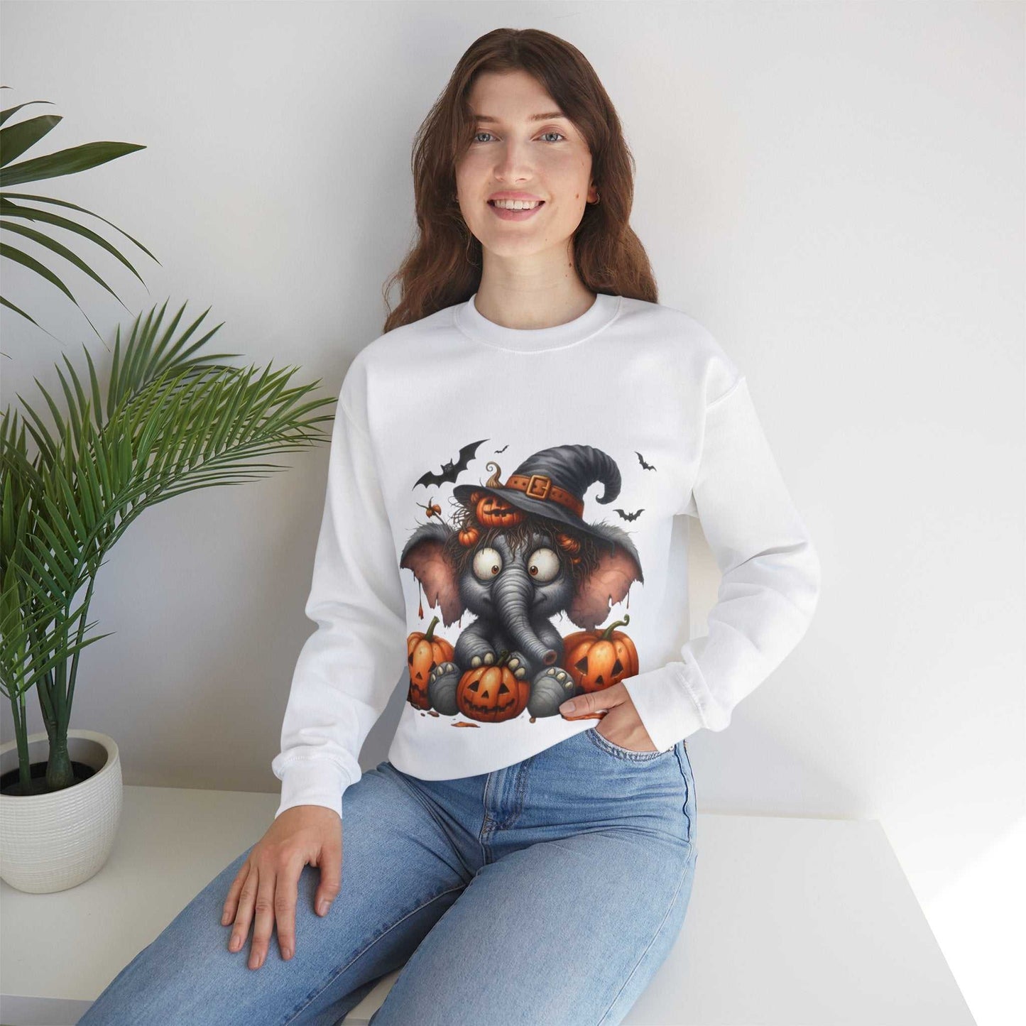 Woman wearing a Funny Elephant Halloween Sweetshirt with Halloween design featuring an elephant, pumpkins, and bats.