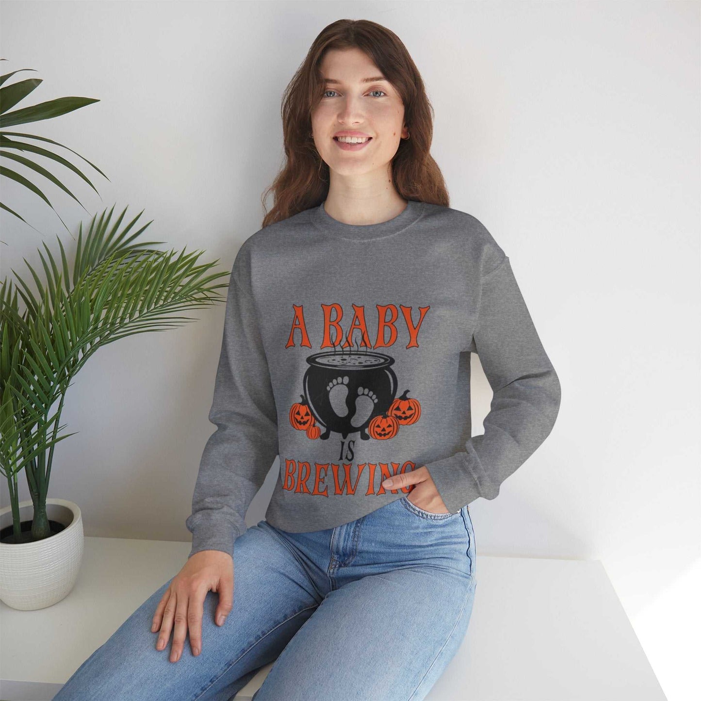 Unisex "A Baby Is Brewing" sweatshirt for Halloween pregnancy announcement, polyester-cotton blend.