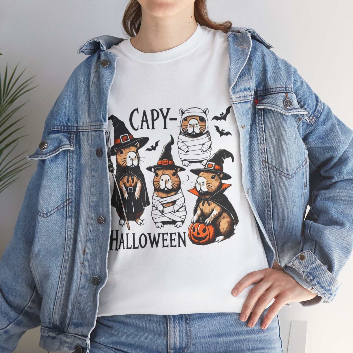 Unisex Halloween Capybara Shirt featuring cute capybaras in spooky costumes and pumpkins.
