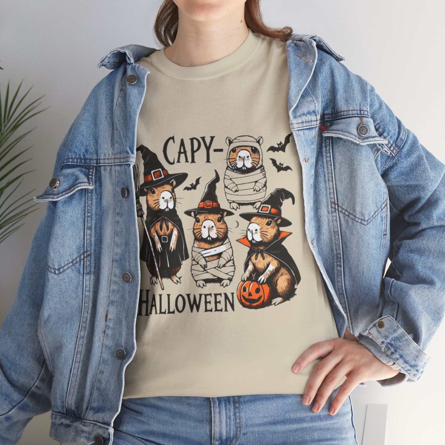 Halloween Capybara Shirt featuring spooky capybaras in costumes with pumpkins, perfect for Halloween.