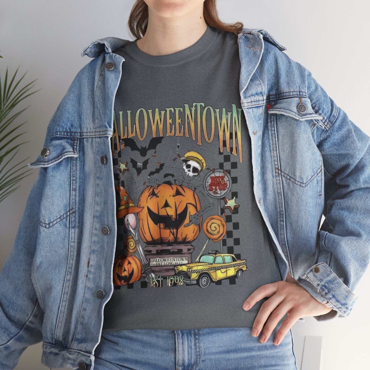 Retro Halloweentown shirt with spooky graphics, worn under a denim jacket for a festive Halloween look.