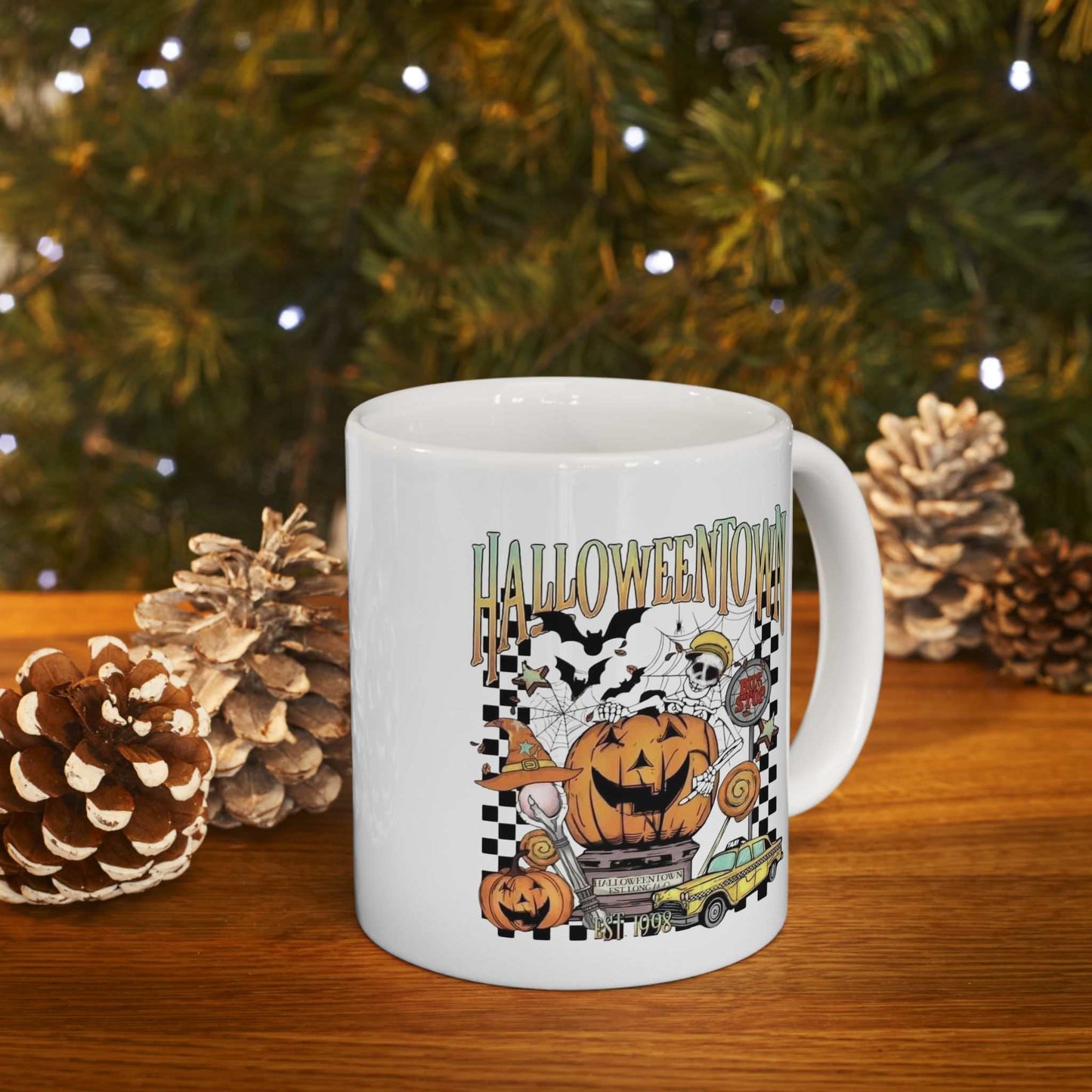 Retro Halloweentown ceramic mug with Halloween-themed design, surrounded by pine cones and festive lights.