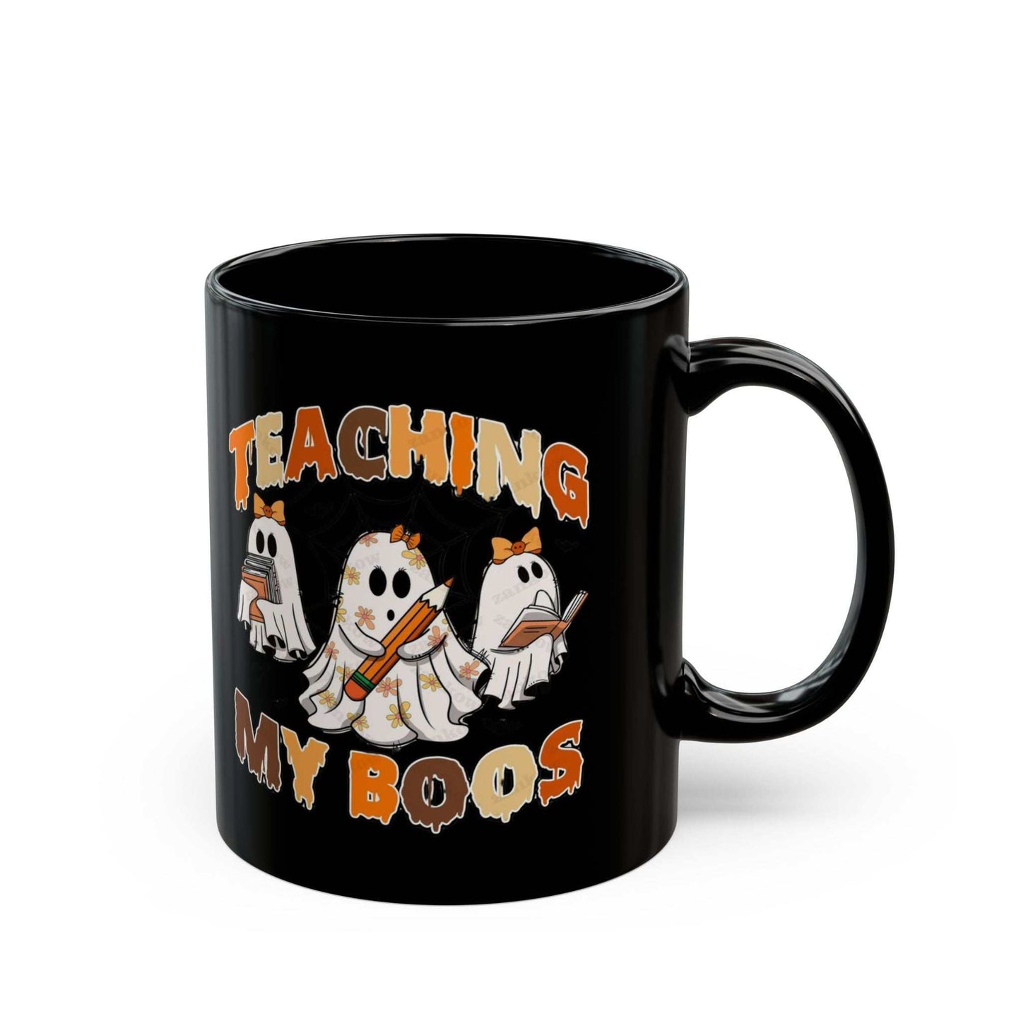 Black ceramic mug with "Teaching My Boos" design featuring cute ghost teachers, perfect for Halloween.