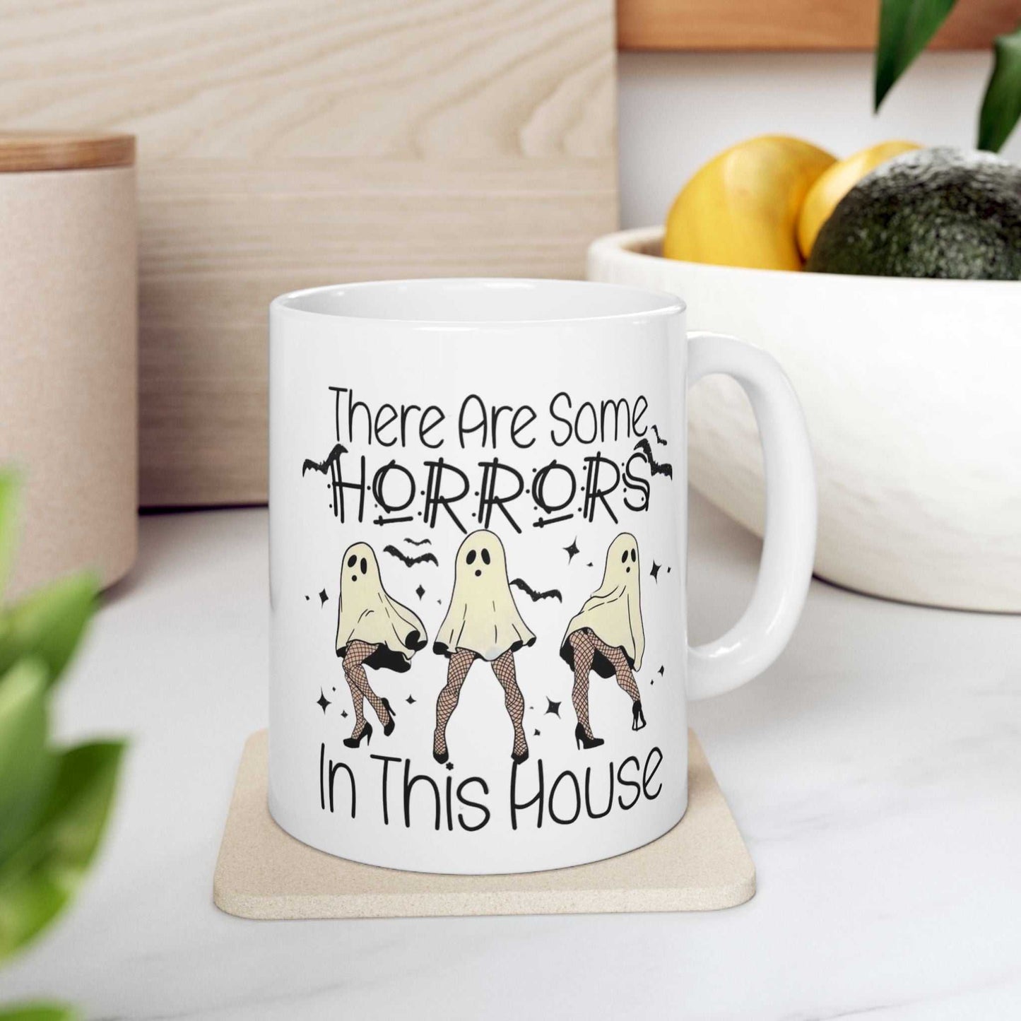 Funny Halloween mug with ghost design and "There Are Some Horrors In This House" text, perfect for spooky season gifts.