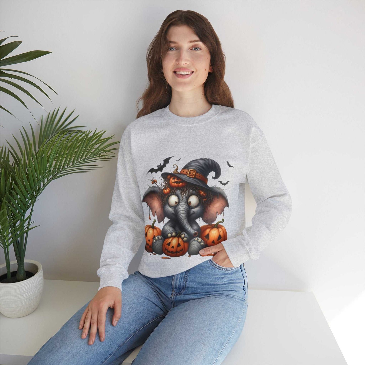 Funny Elephant Halloween Sweetshirt featuring a cute elephant in a witch hat with pumpkins, perfect for spooky season and animal lovers.
