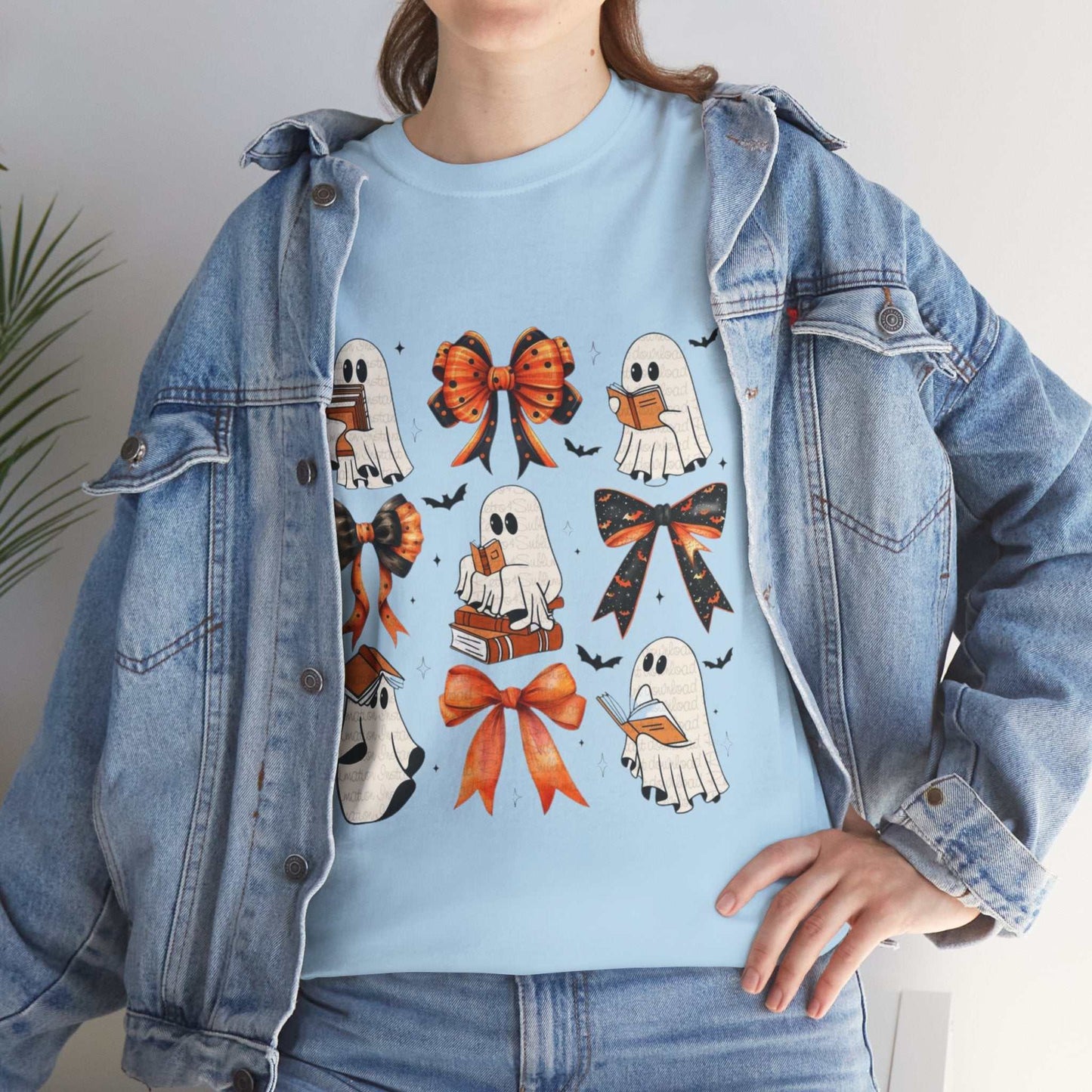 Blue Book Ghost Halloween Shirt featuring cute ghost designs with bows and books, worn with a denim jacket.