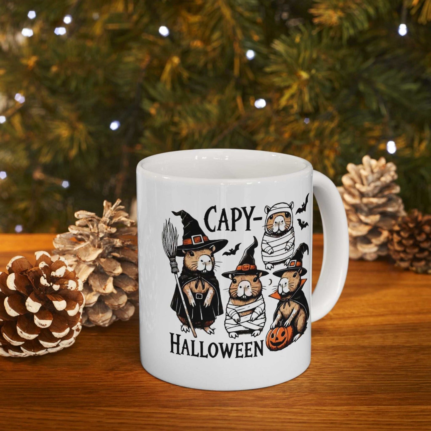 Ceramic mug with Halloween-themed capybara design, featuring capybaras in spooky costumes.