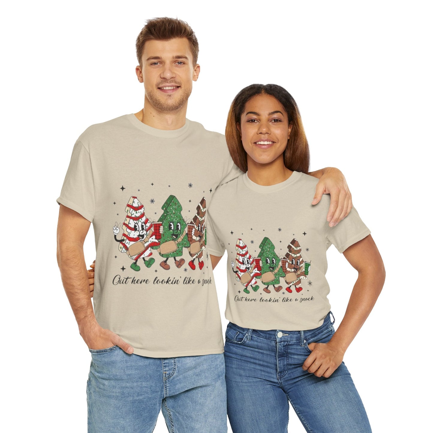 Two people wearing festive "Out Here Looking Like a Snack" Christmas shirts with holiday-themed graphics.