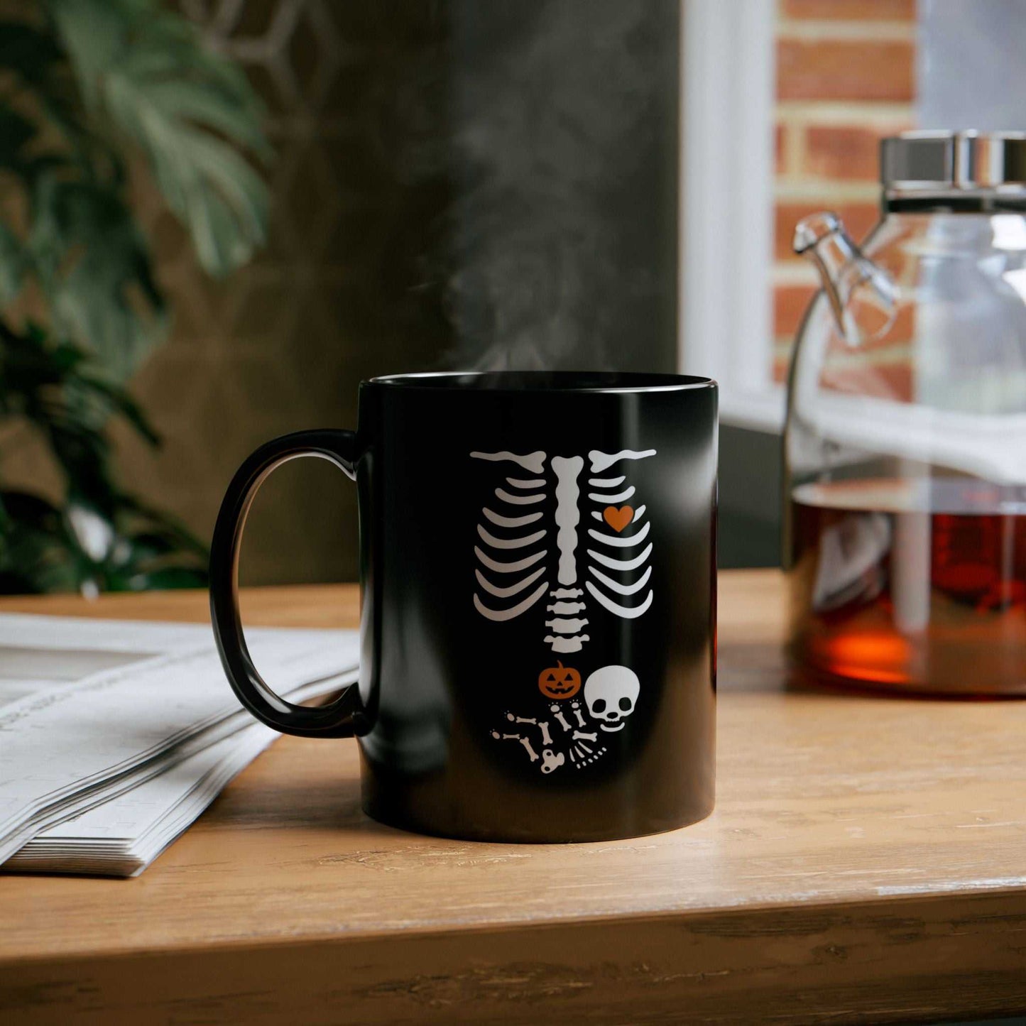 Black ceramic Halloween maternity mug with skeleton design, perfect for pregnancy announcements and gifts for new moms.