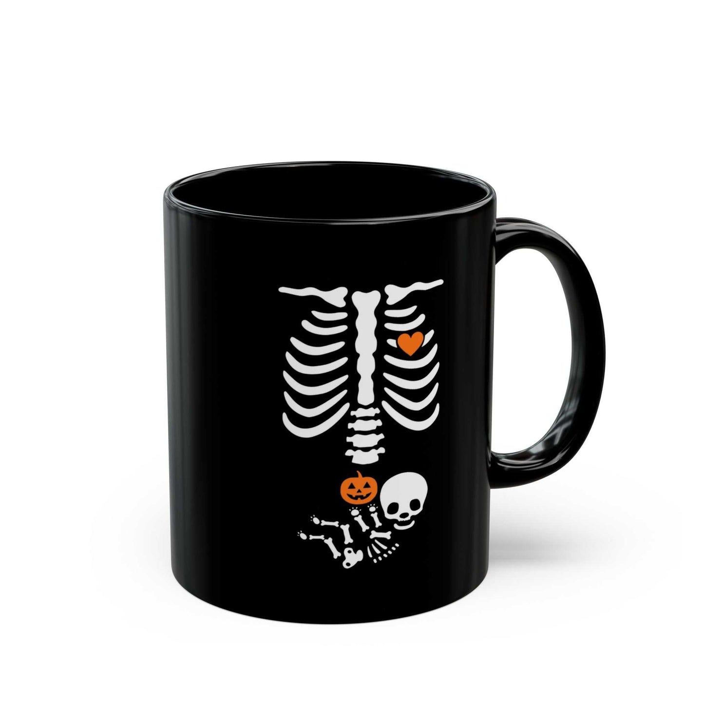 Black ceramic Halloween maternity mug with skeleton design and pumpkin, perfect for pregnancy reveals.