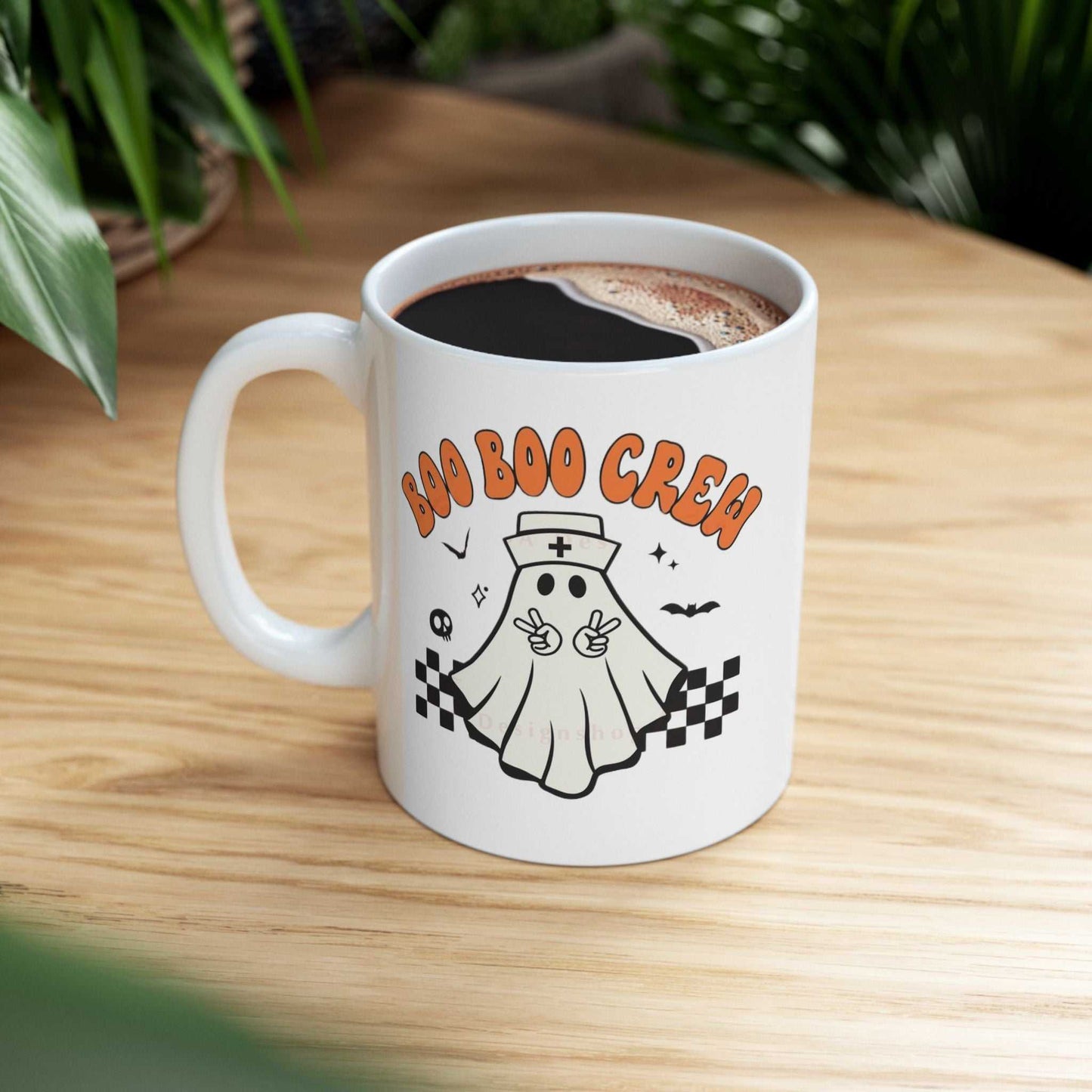Ceramic coffee mug featuring a "Boo Nurse Crew Halloween" design with a cute ghost nurse illustration, perfect for Halloween gifts.
