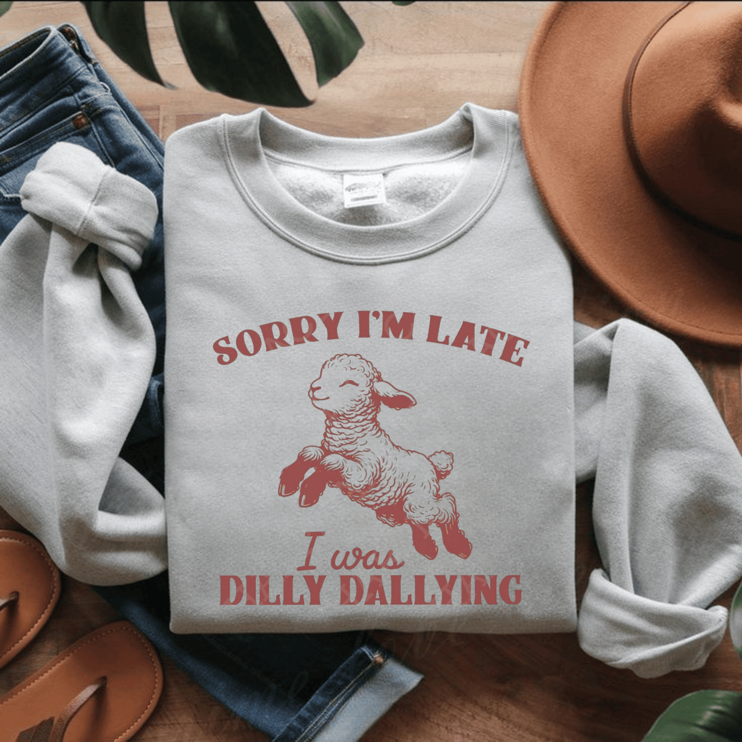 Funny unisex crewneck sweatshirt with "Sorry I'm Late, I Was Dilly Dallying" design, featuring a playful lamb illustration, perfect for casual wear.