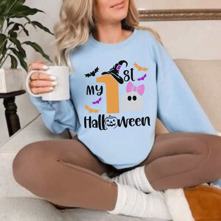 Baby Halloween sweatshirt with ghost design and "1st Halloween" text.