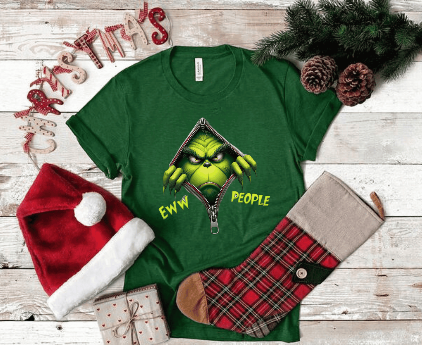 Grinch Ew People Shirt displayed with Christmas decorations, featuring a funny Grinch design.