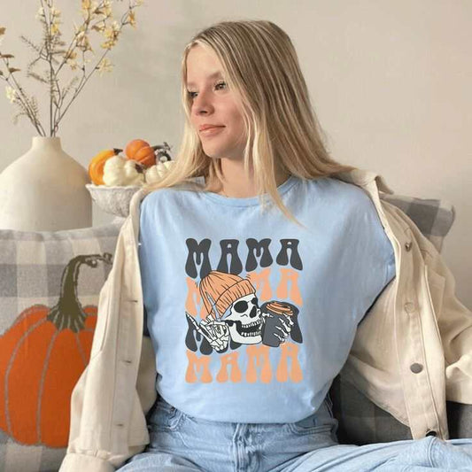 Woman wearing a "Mama Coffee" Halloween shirt with festive design, perfect for coffee lovers during the holiday season.
